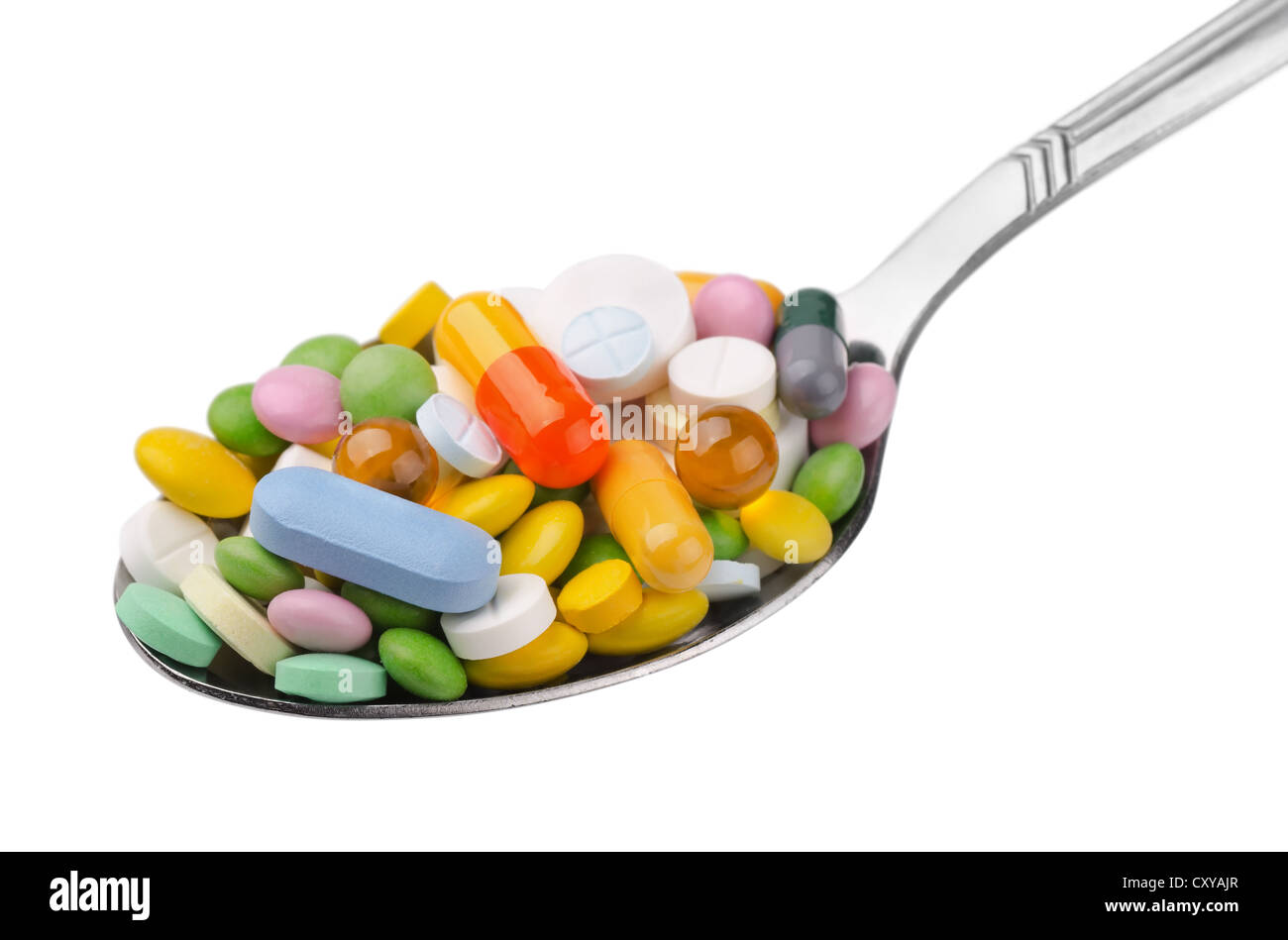 Spoon full of various colorful drugs isolated on white Stock Photo