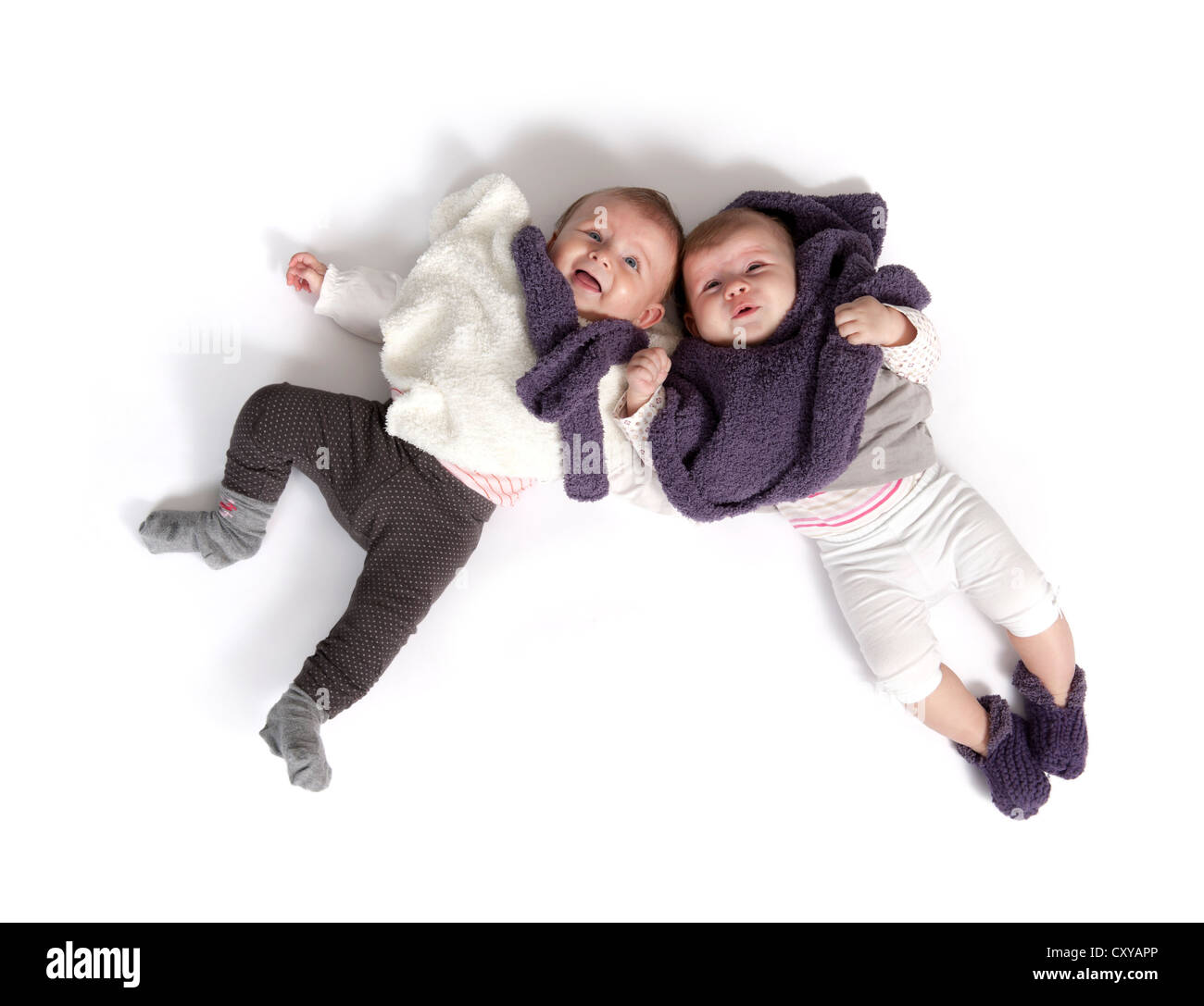 two babies lying on the floor Stock Photo Alamy