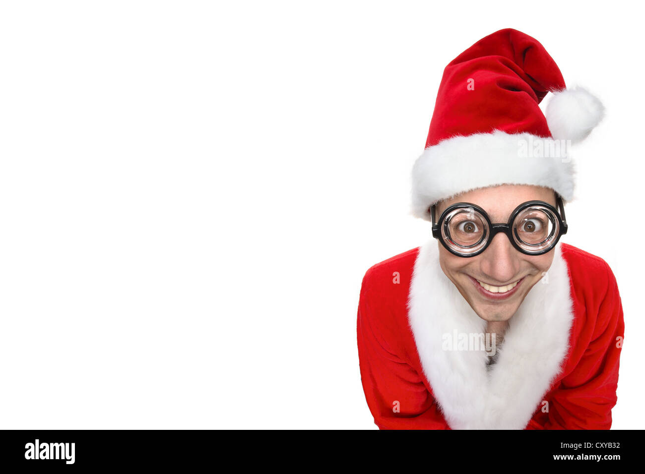 Smiling man dressed as Santa Claus wearing oversized novelty glasses Stock Photo