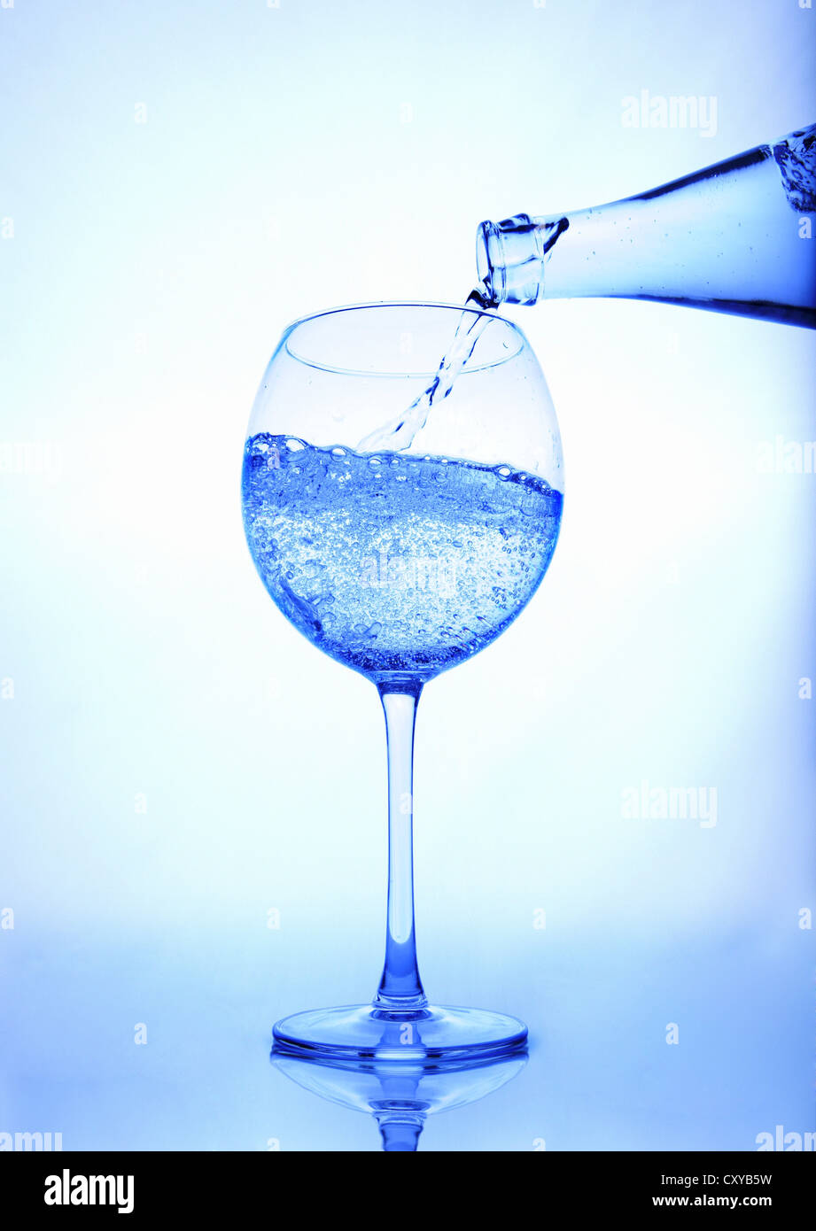 Mineral water being poured into a glass Stock Photo