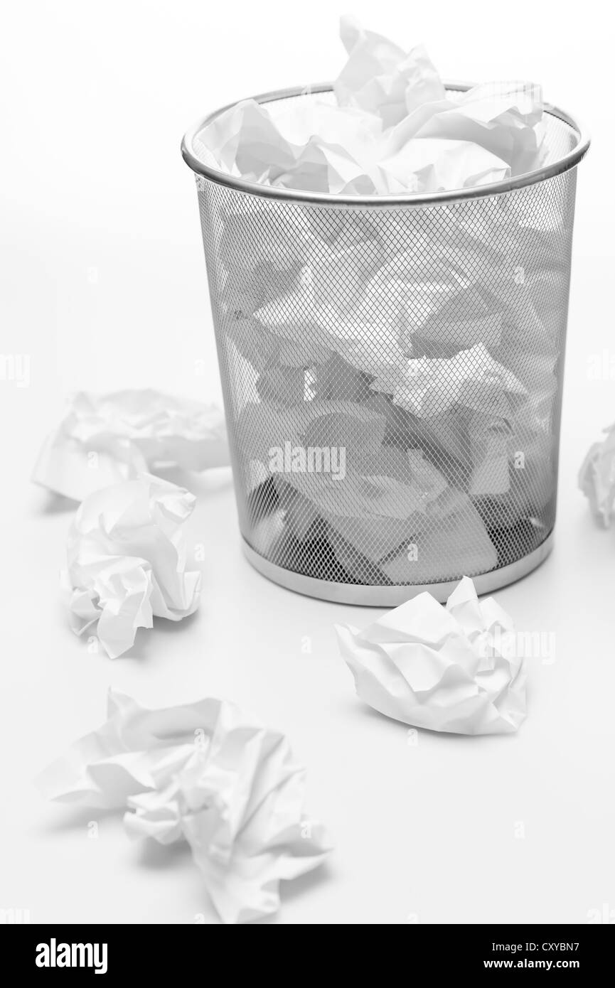 Office silver trash bin full of paper waste white isolated Stock Photo