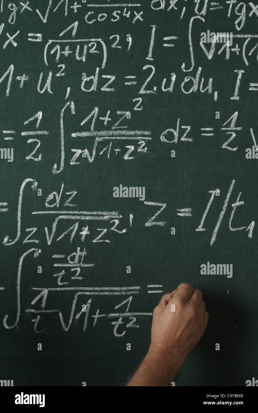 Mathematics lesson, school blackboard with a hand writing, integral calculus Stock Photo