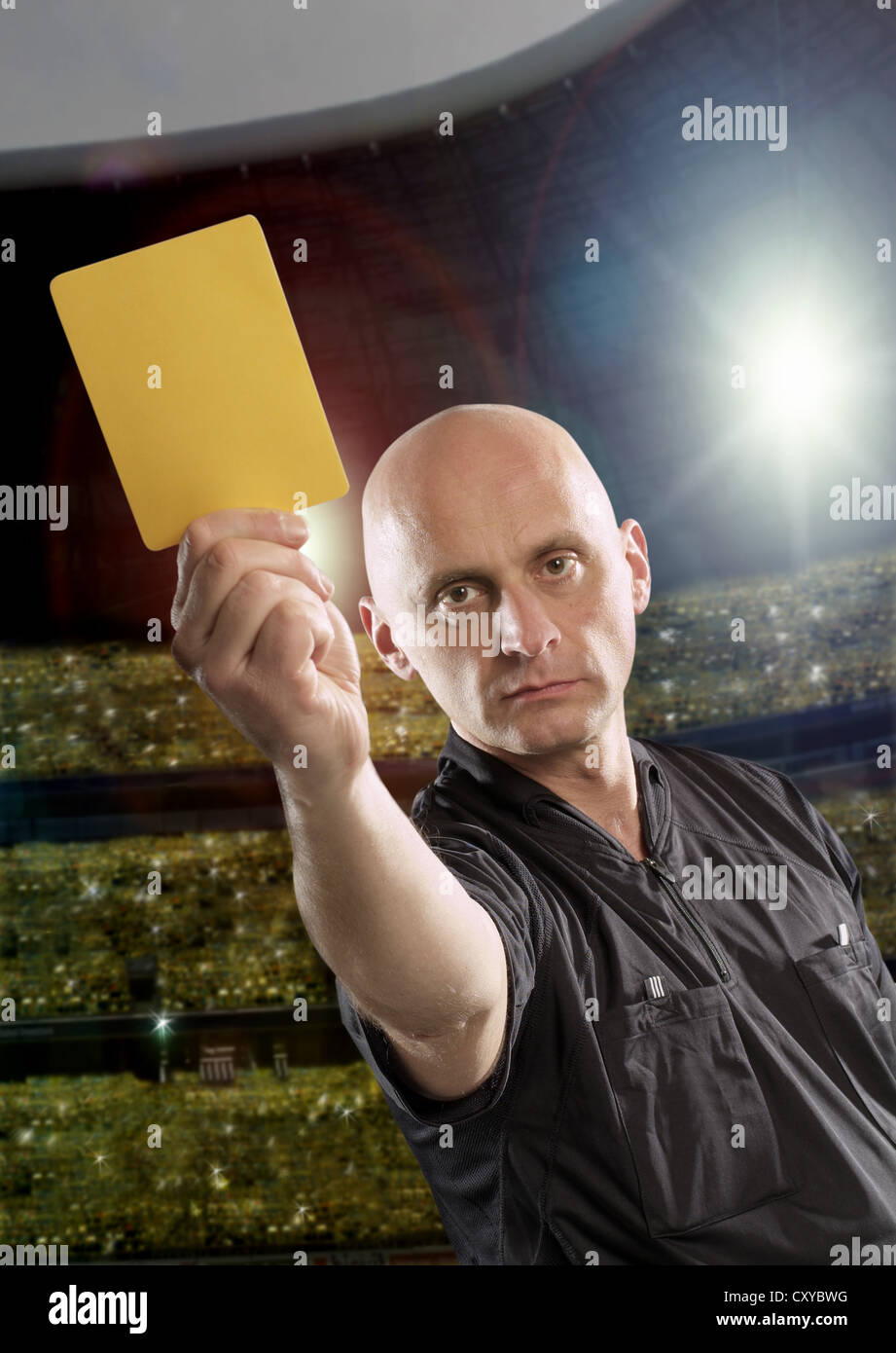 Referee holding a yellow card Stock Photo Alamy