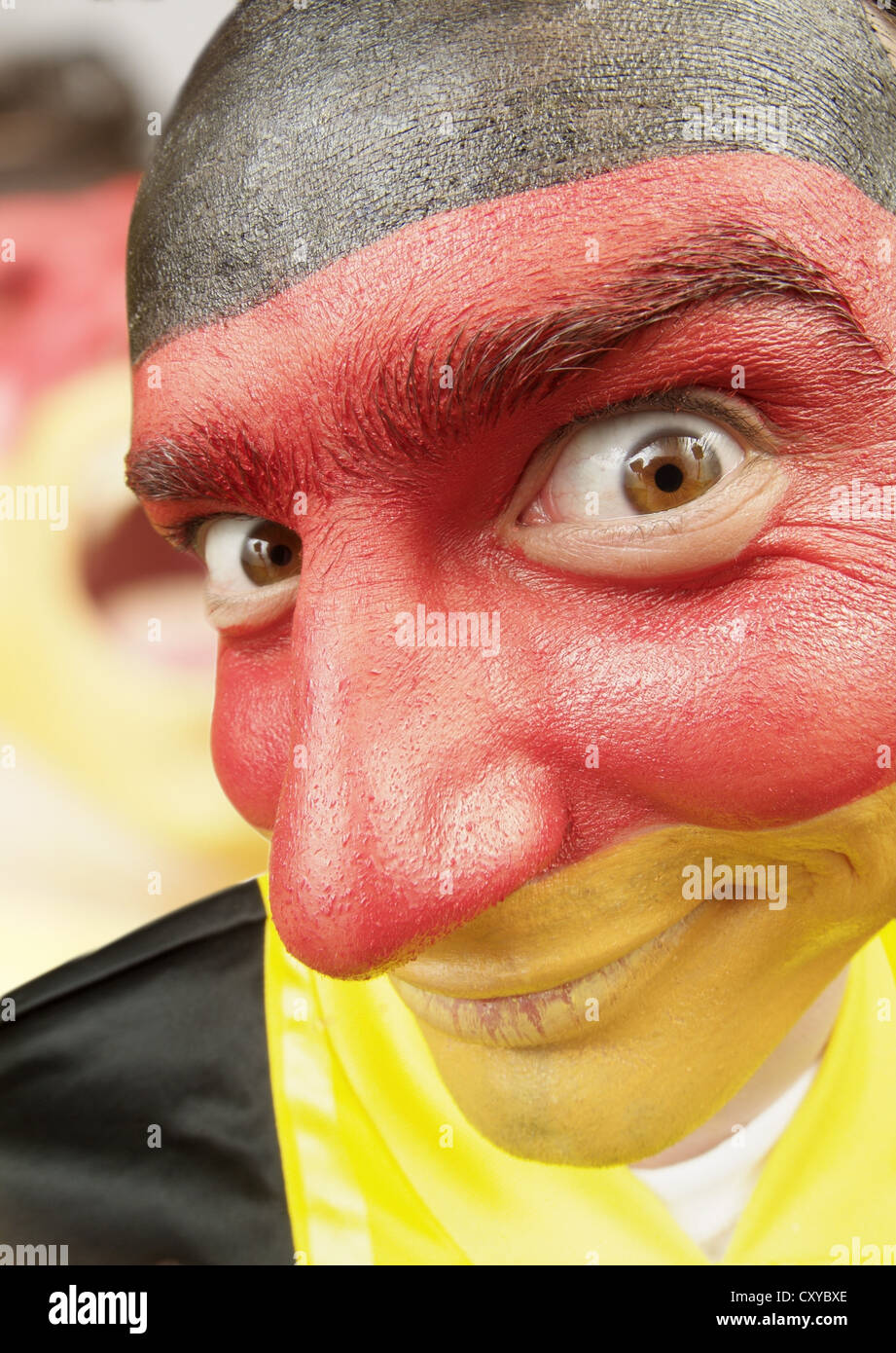 Football fan with his face painted in the national colours of Germany Stock Photo
