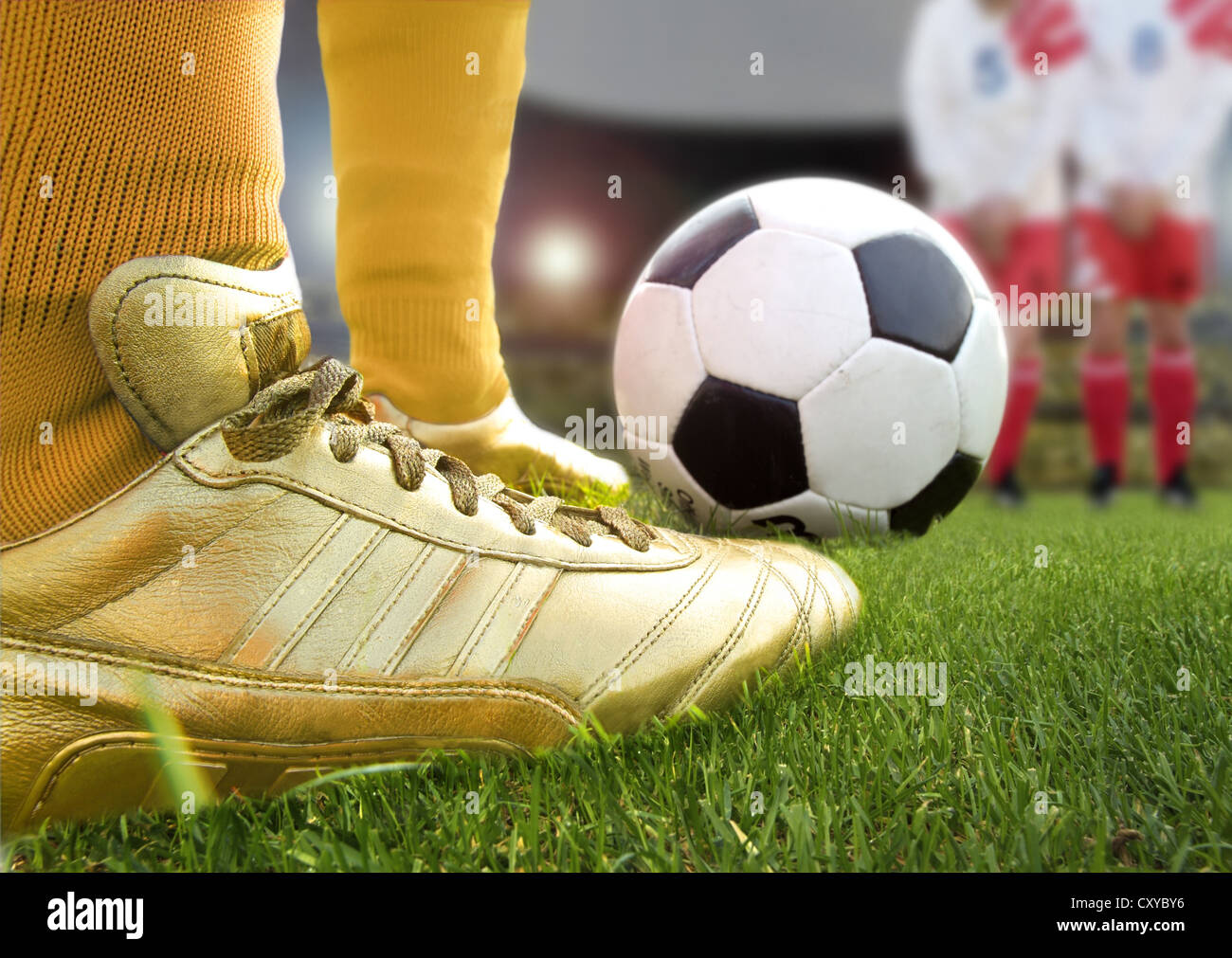 Football player, detail, wearing golden football boots Stock Photo