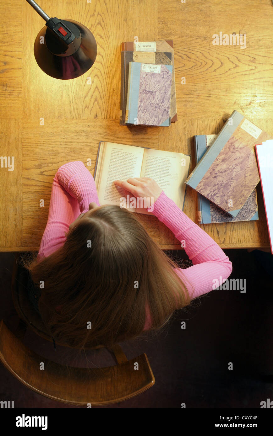 Student sitting at a desk in a university library, view from above ...