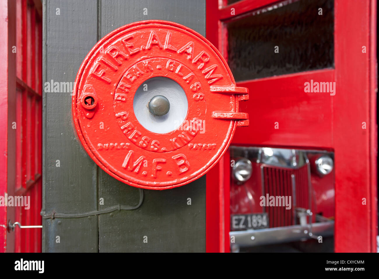 Historic fire alarm, old fire engine at back Stock Photo