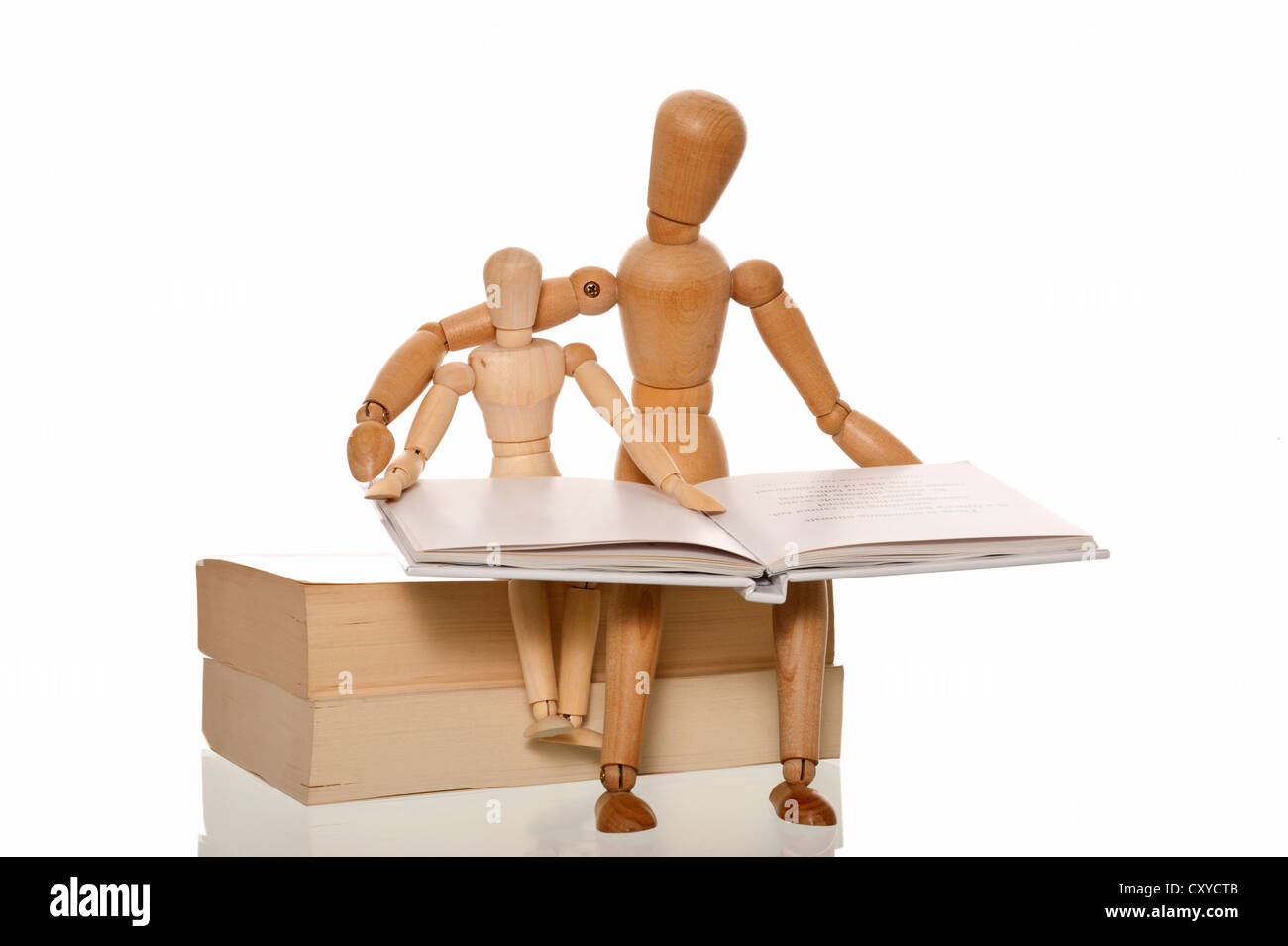 Mannequin reading a book to a smaller mannequin Stock Photo Alamy
