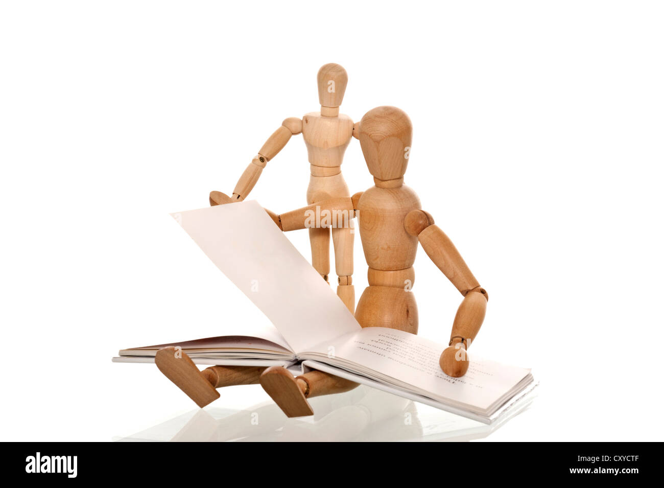 Mannequin reading a book to a smaller mannequin Stock Photo