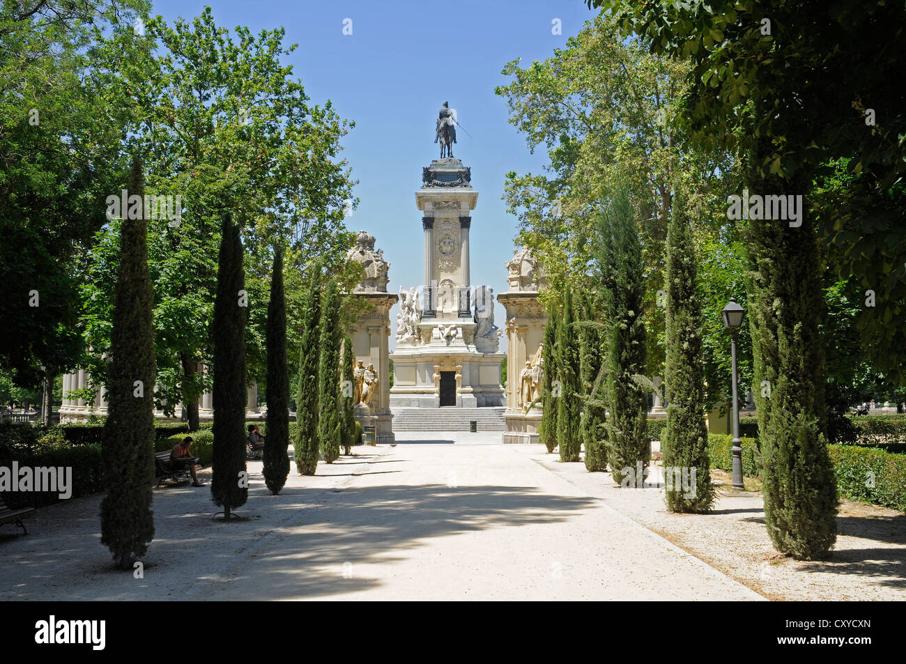 Equestrian statue of King Alfonso XII, treelined avenue, Retiro Park
