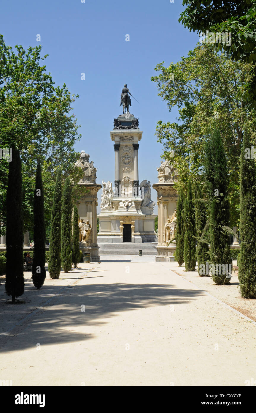 Equestrian statue of King Alfonso XII, treelined avenue, Retiro Park