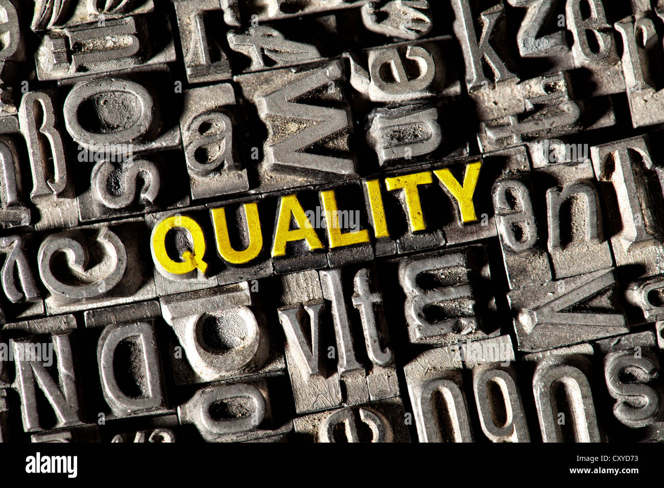 Old lead letters spelling the word QUALITY Stock Photo