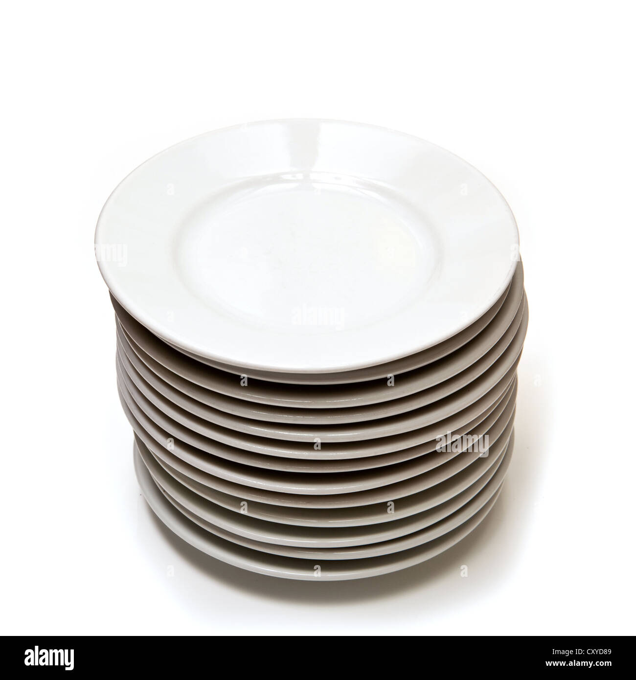 Pile of white china plates isolated on a white studio background. Stock Photo