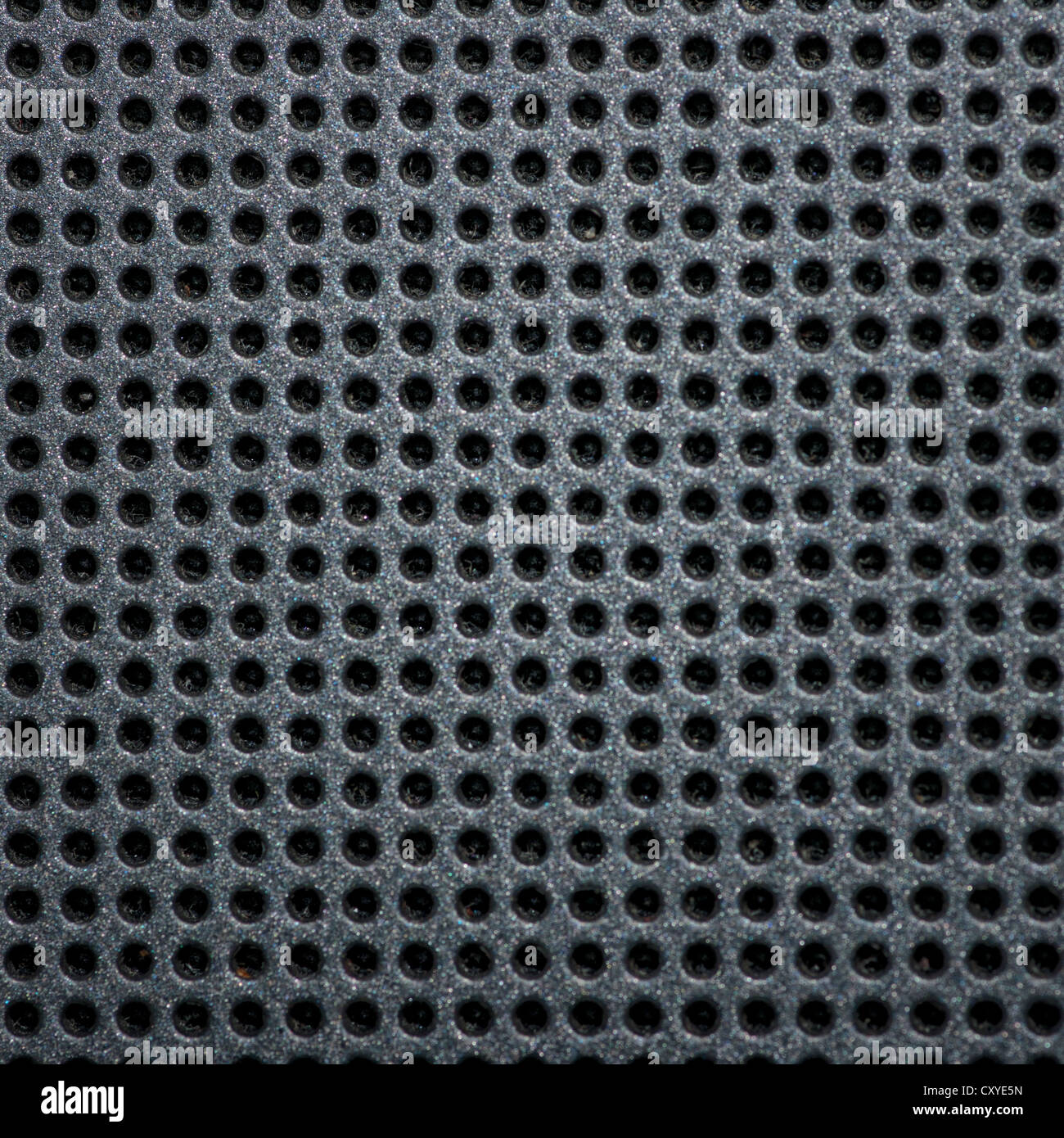 Black, metallic sheet with holes. Stock Photo