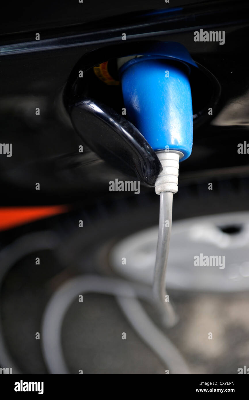 Electric car being recharged at a power outlet Stock Photo Alamy