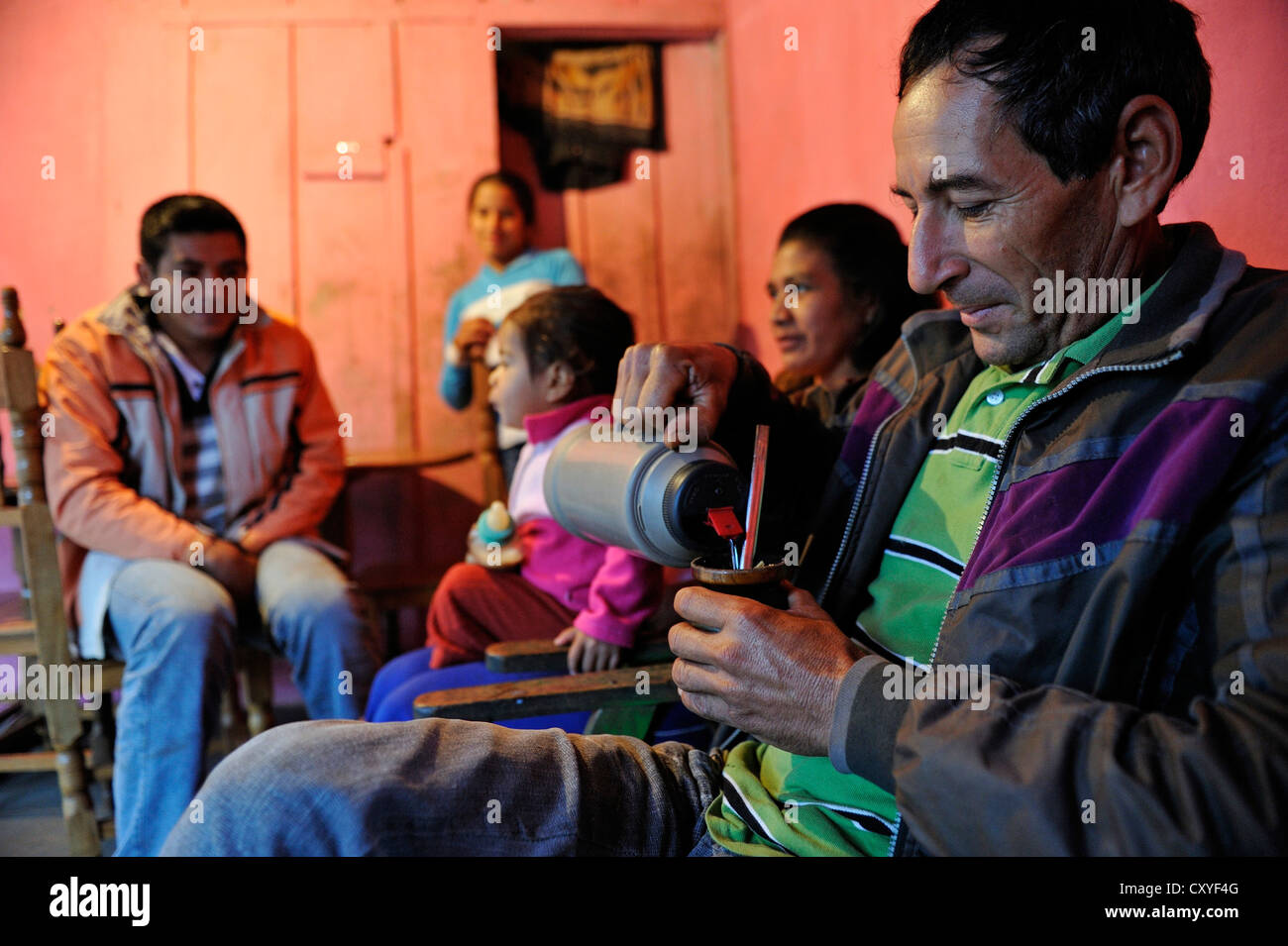 Man, father, drinking the traditional mate tea of Paraguay, family of smallholders, Comunidad Arroyito, Departamento Concepcion Stock Photo