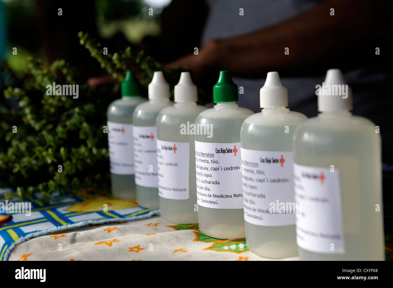 Medicine in plastic bottles, made from the herbs of the village's garden for medicinal plants; project of the SRC or Swiss Red Stock Photo