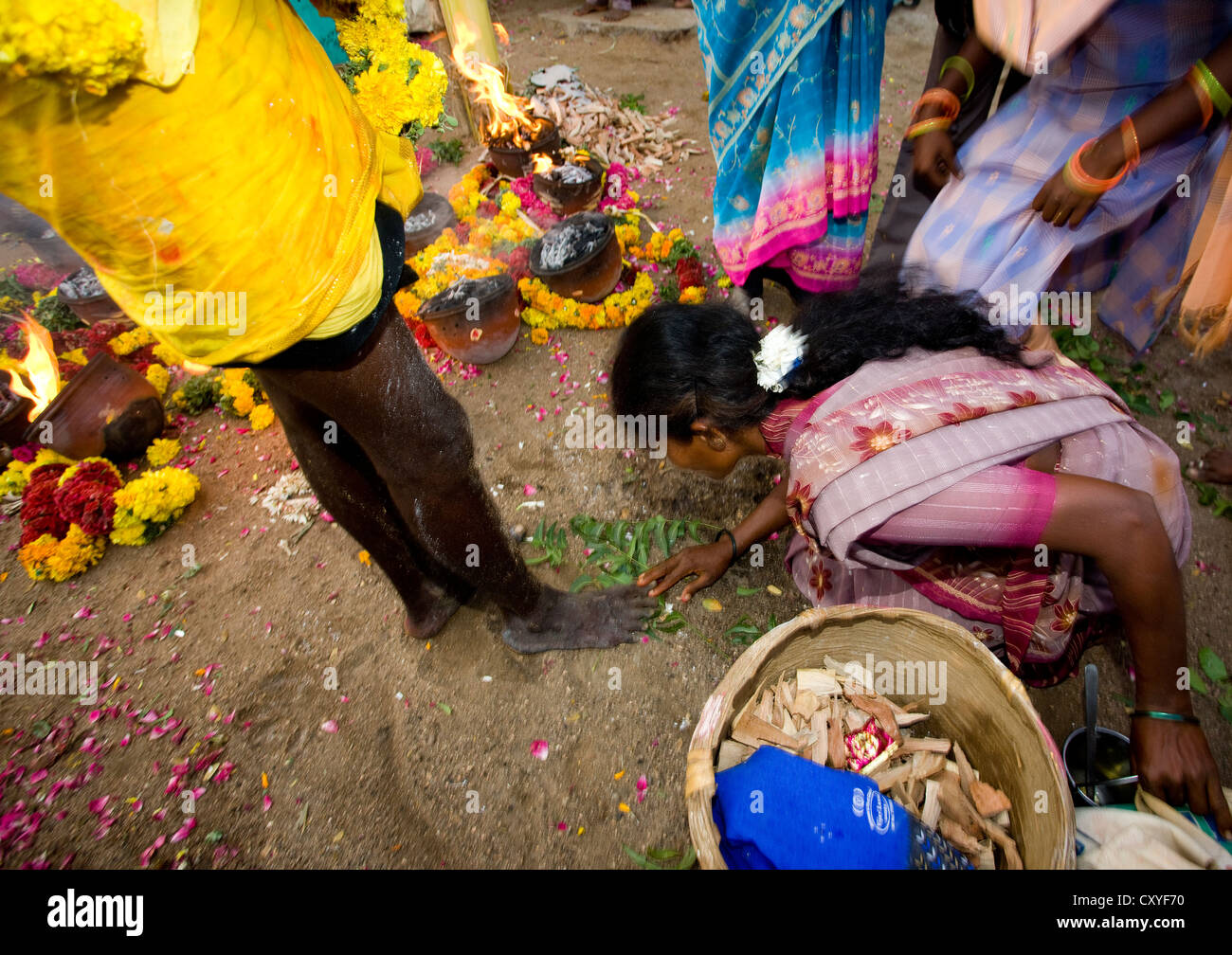 Woman Inspecting The Ashes Covered Feet Of Someone Who Succeeded At Fire Walking Ritual, Madurai, South India Stock Photo