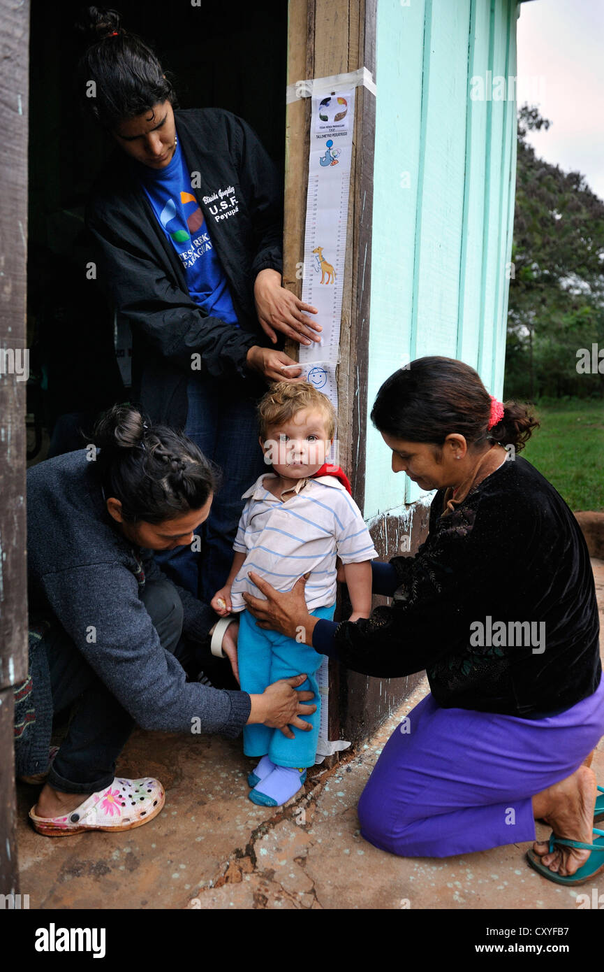 The height of a boy is being measured, aid organisation providing health services and education for mothers and children in Stock Photo