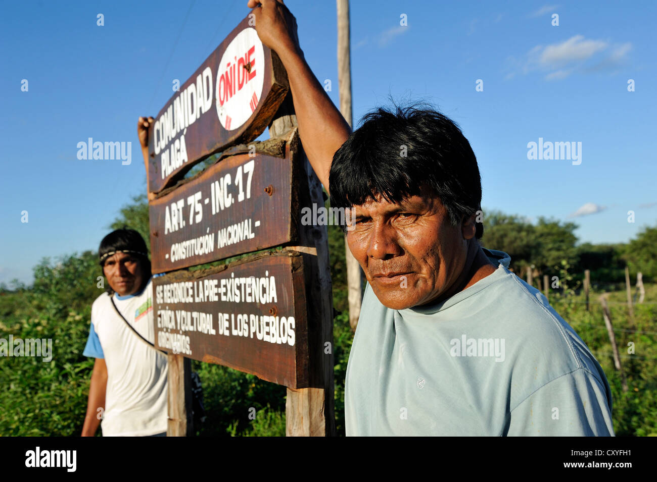 Leader of the Onedi village standing next to a sign at the entrance to his village, indigenous Pilaga people, Gran Chaco Stock Photo