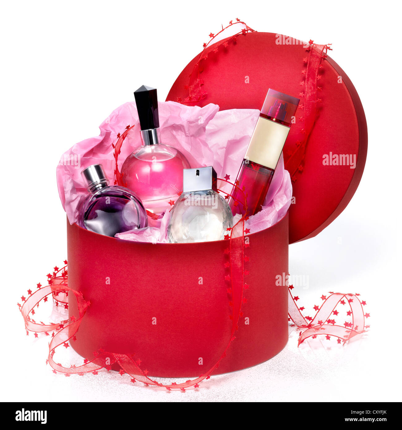 Perfumery gift set in a red box on white background. With a Christmas bow and a little of purpurin effect. Stock Photo