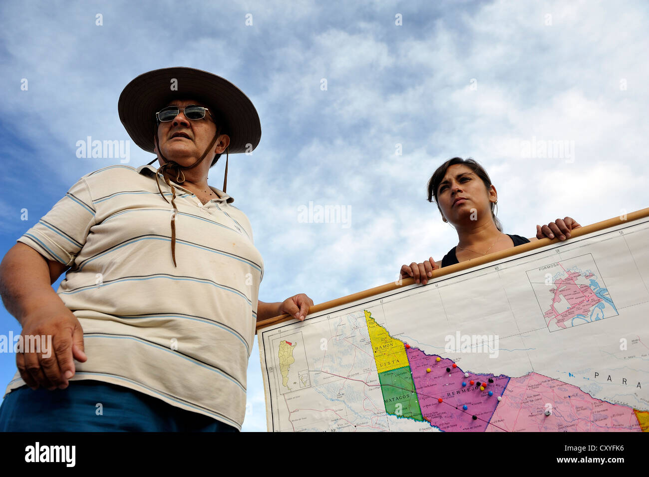Environmental activists with a map of the floodplains of the Pilcomayo river, the area is being destroyed by a project supported Stock Photo