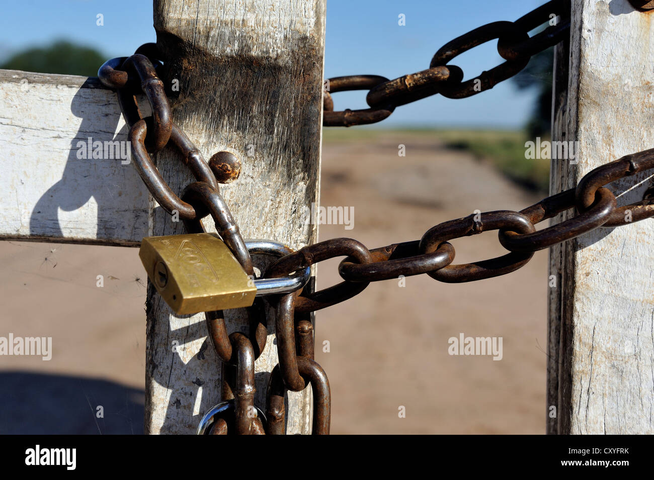 Padlock on a wooden gate of a great land owner, soybean farmers, Gran Chaco, Santiago del Estero province, Argentina Stock Photo