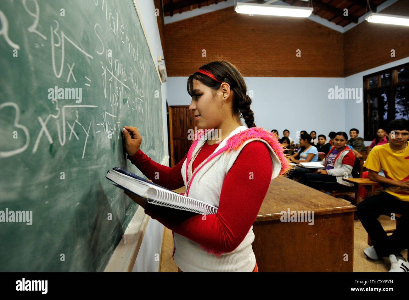 Student solving a math equation, equation on a blackboard, lessons at the agricultural college CECTEC, Itapua, Paraguay Stock Photo