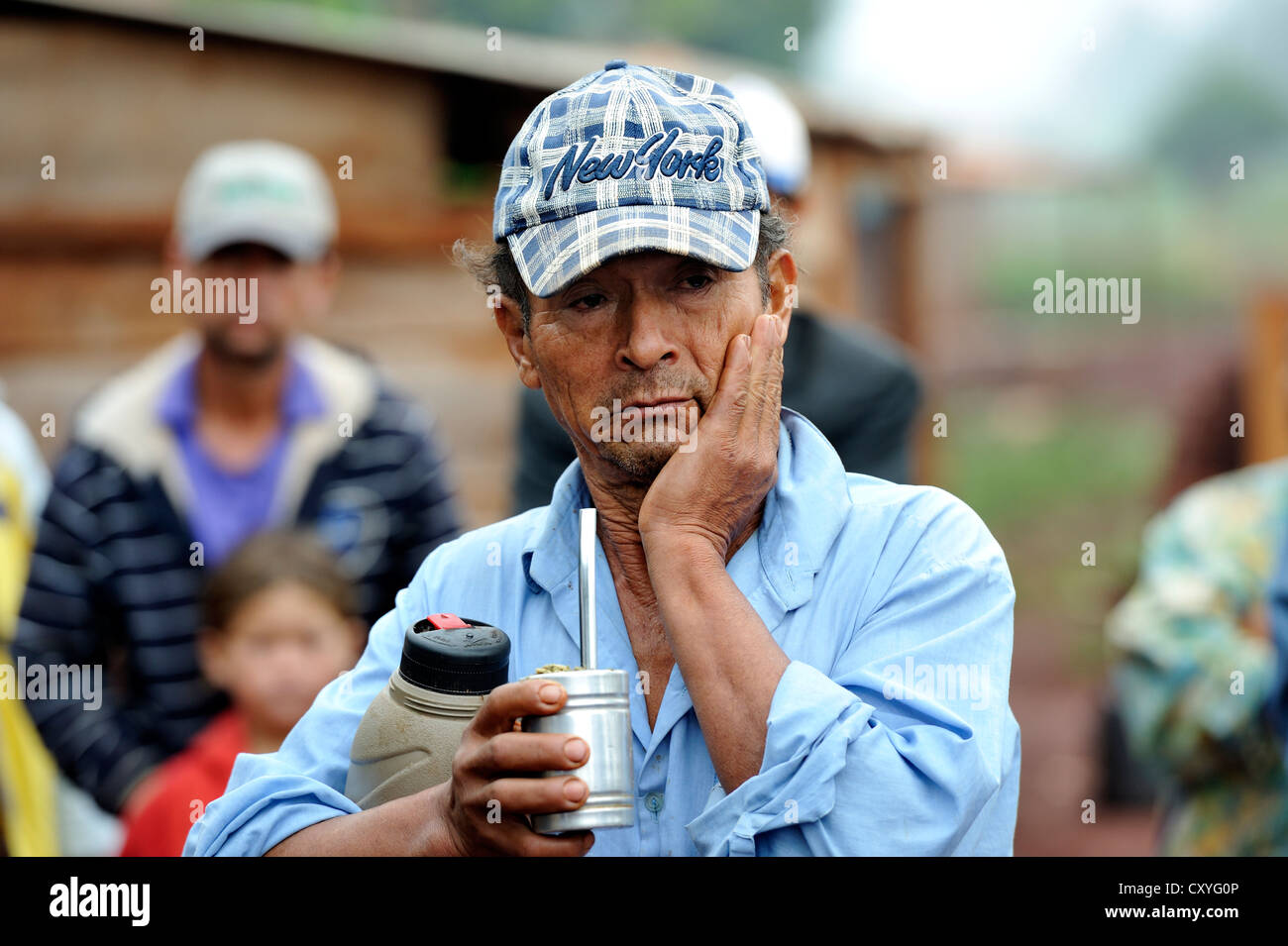 Farmer with a worried expression is drinking the Paraguayan national drink 'Terere' made from mate, he was evicted from his land Stock Photo