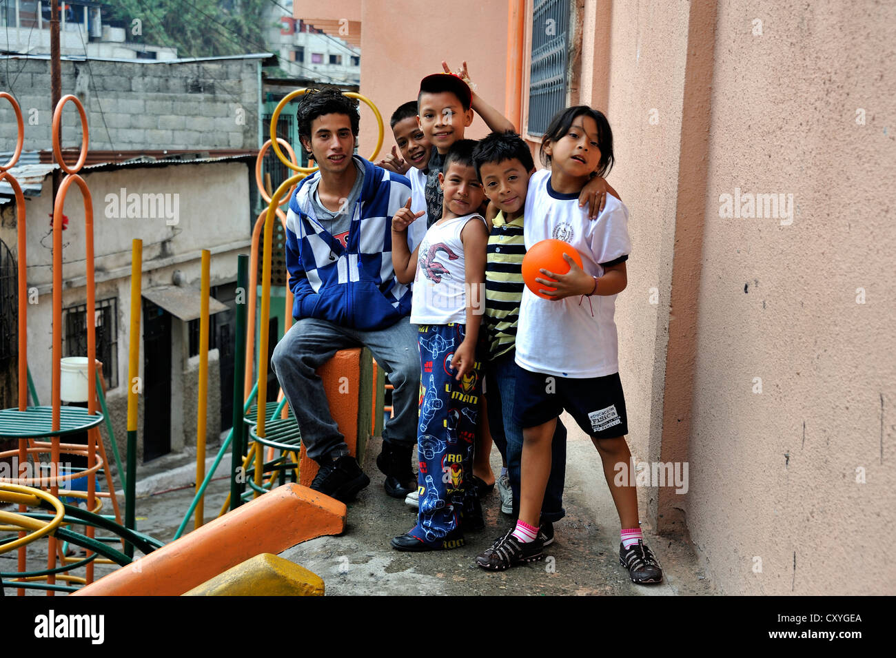 Young man, 18 years old, a former hired killer and member of a gang of youths, Mara, in his former district surrounded by Stock Photo