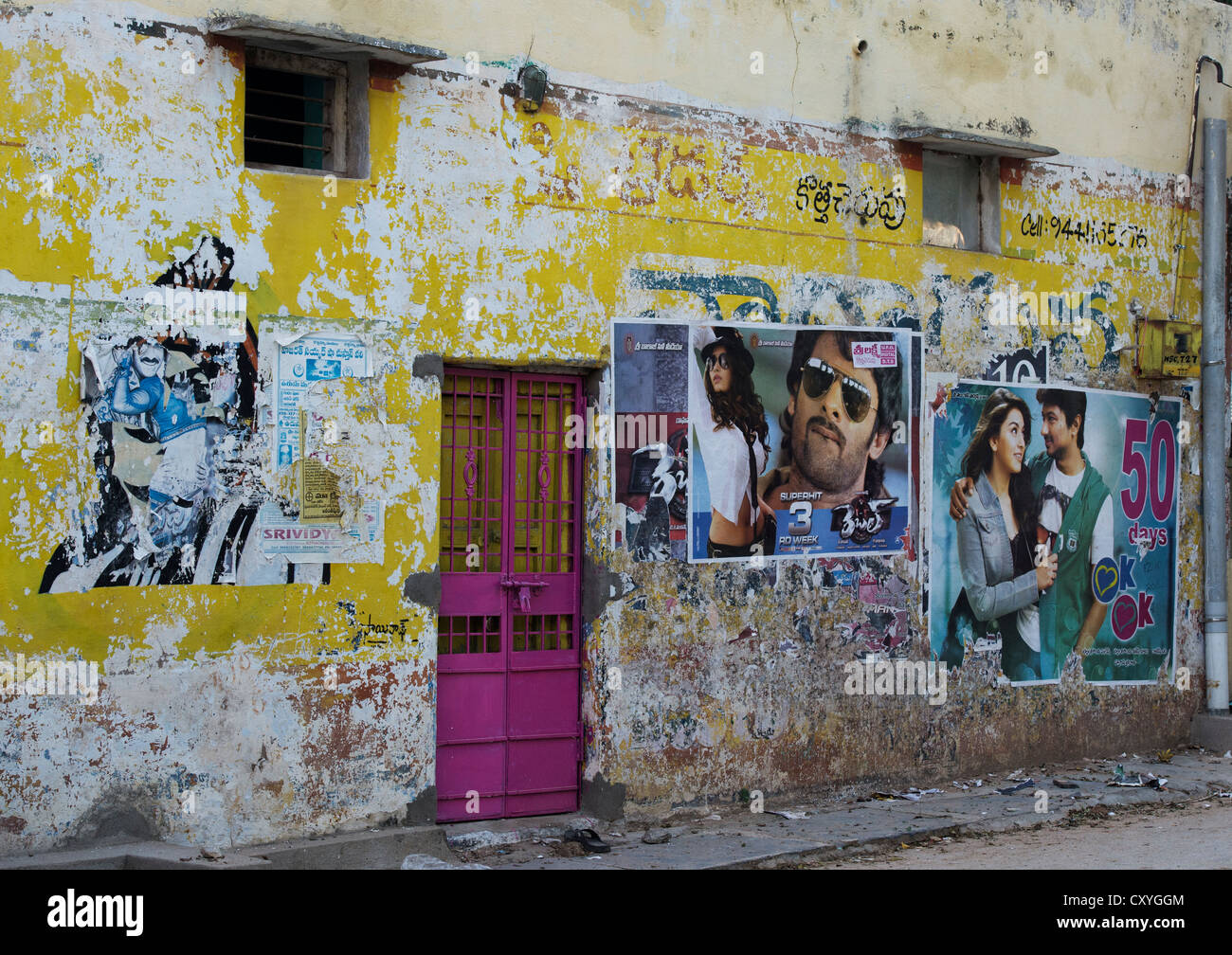 Pink metal security door in a tatty indian house. Andhra Pradesh, India Stock Photo