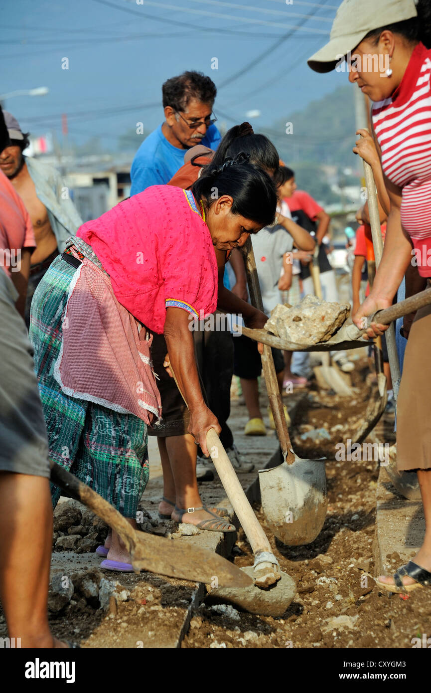 Women working together to improve the sewer system of their neighborhood, Lomas de Santa Faz slum, Guatemala City, Guatemala Stock Photo
