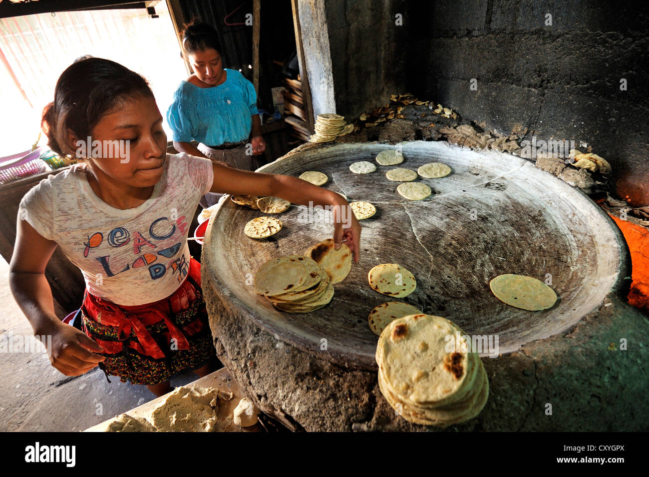 Tortillas being made in a kitchen, Lomas de Santa Faz slum, Guatemala City, Guatemala, Central America Stock Photo