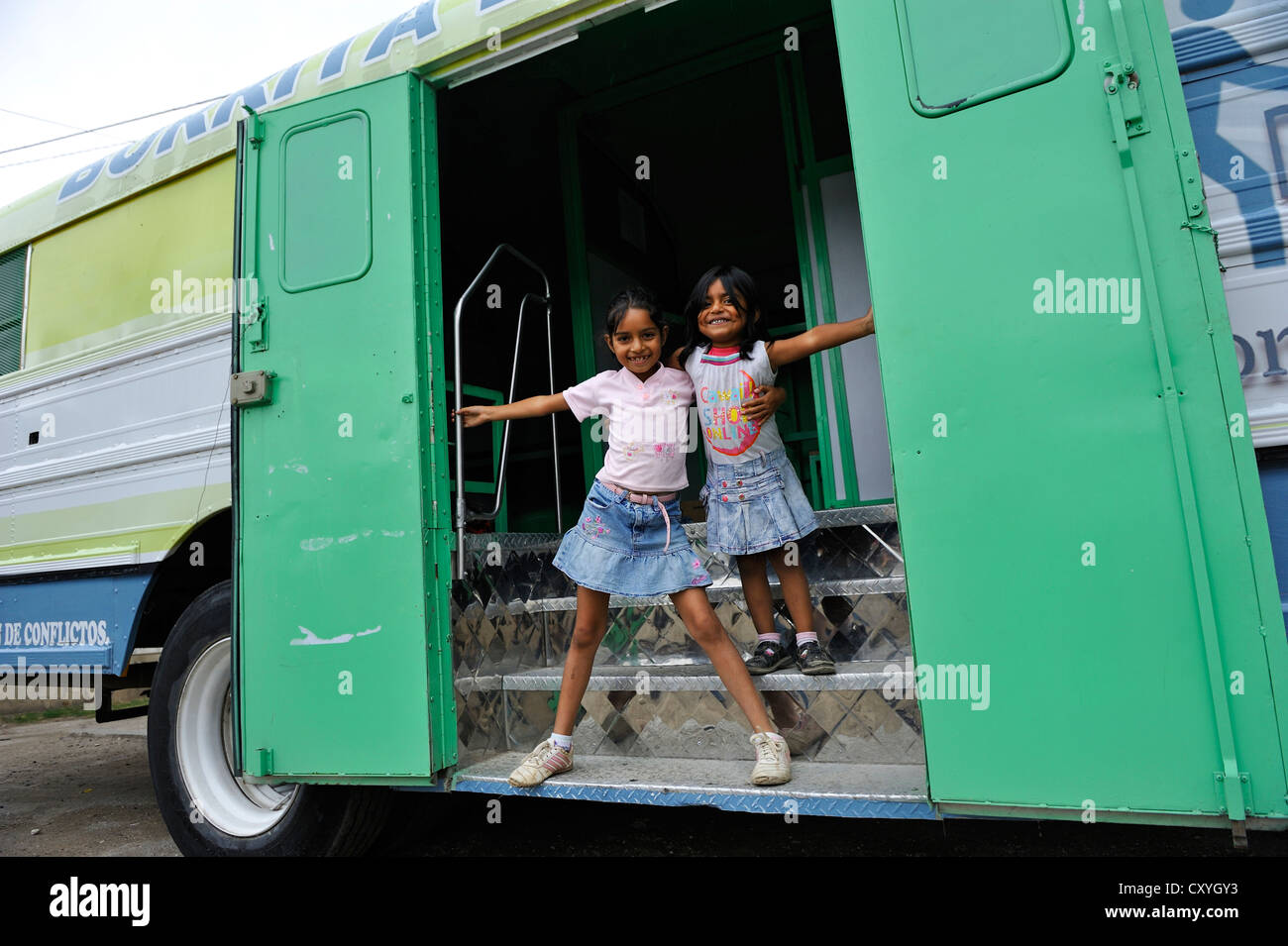 Two girls standing at the entrance of a truck, 'La Burrita de La Paz' truck, the 'peace donkey' truck, the human rights Stock Photo