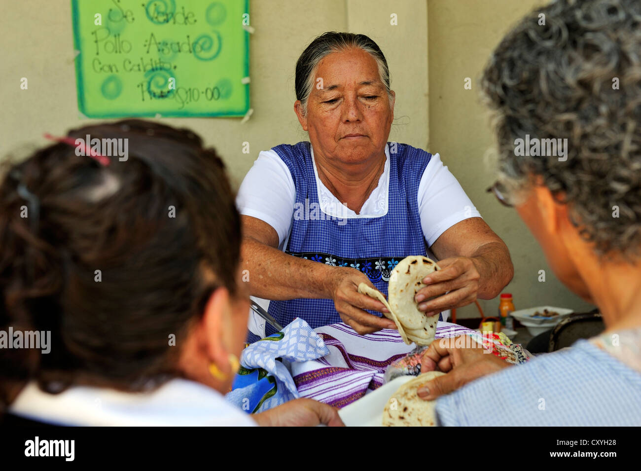 Woman offering tortillas for sale at a stand, feast on the day of St. Anthony, Dios Con Nosotros church parish, El Mesquital Stock Photo