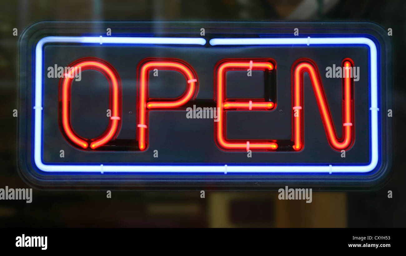 An open sign in the window of a retail establishment Stock Photo