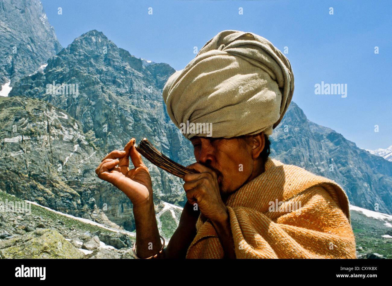Shiva Sadhu smoking marihuana high up in the the mountains above Badrinath, Uttaranchal, India, Asia Stock Photo