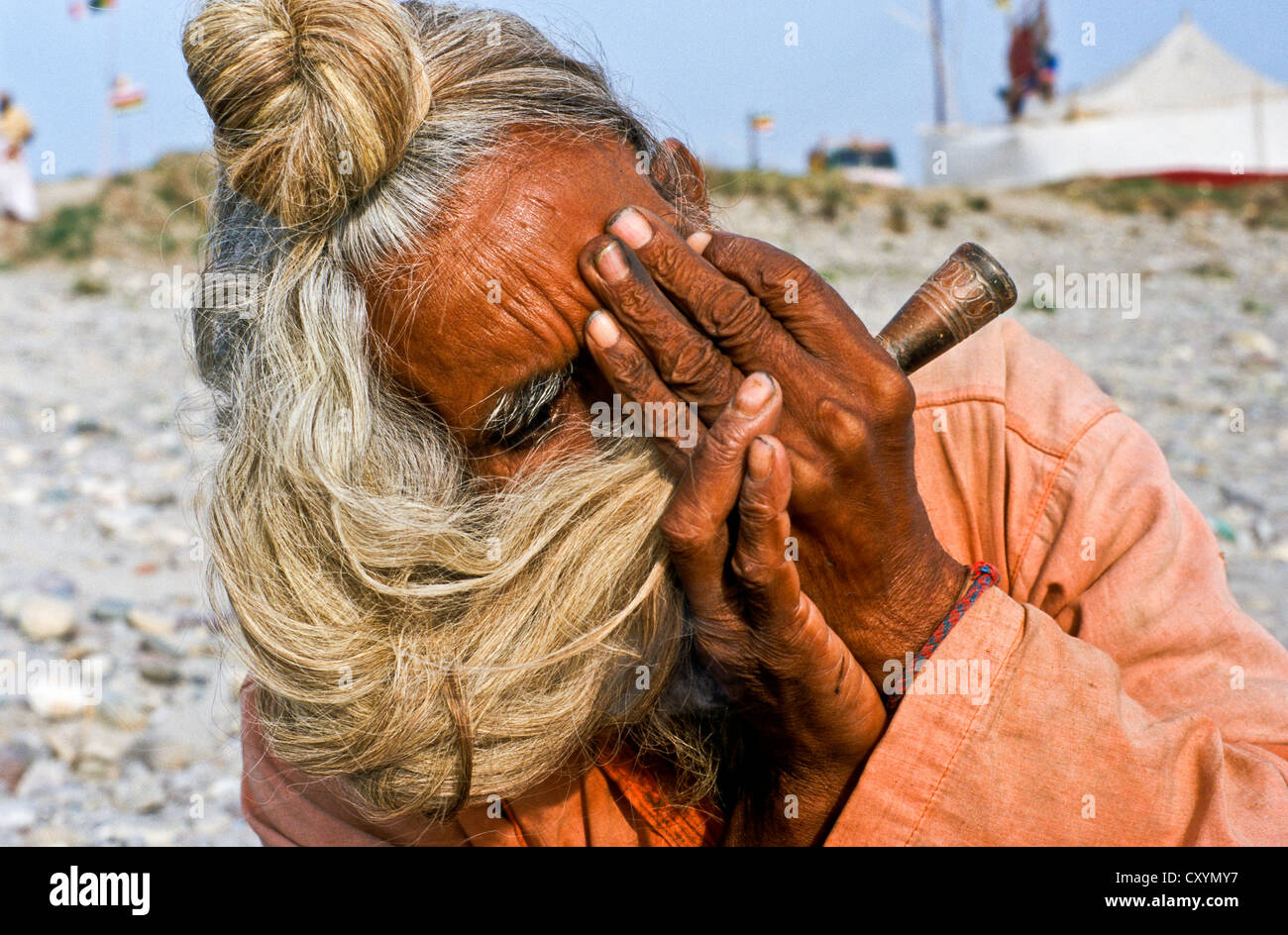 Sadhu, holy man, smoking marihuana during Kumbh Mela or Kumbha Mela, Haridwar, India, Asia Stock Photo