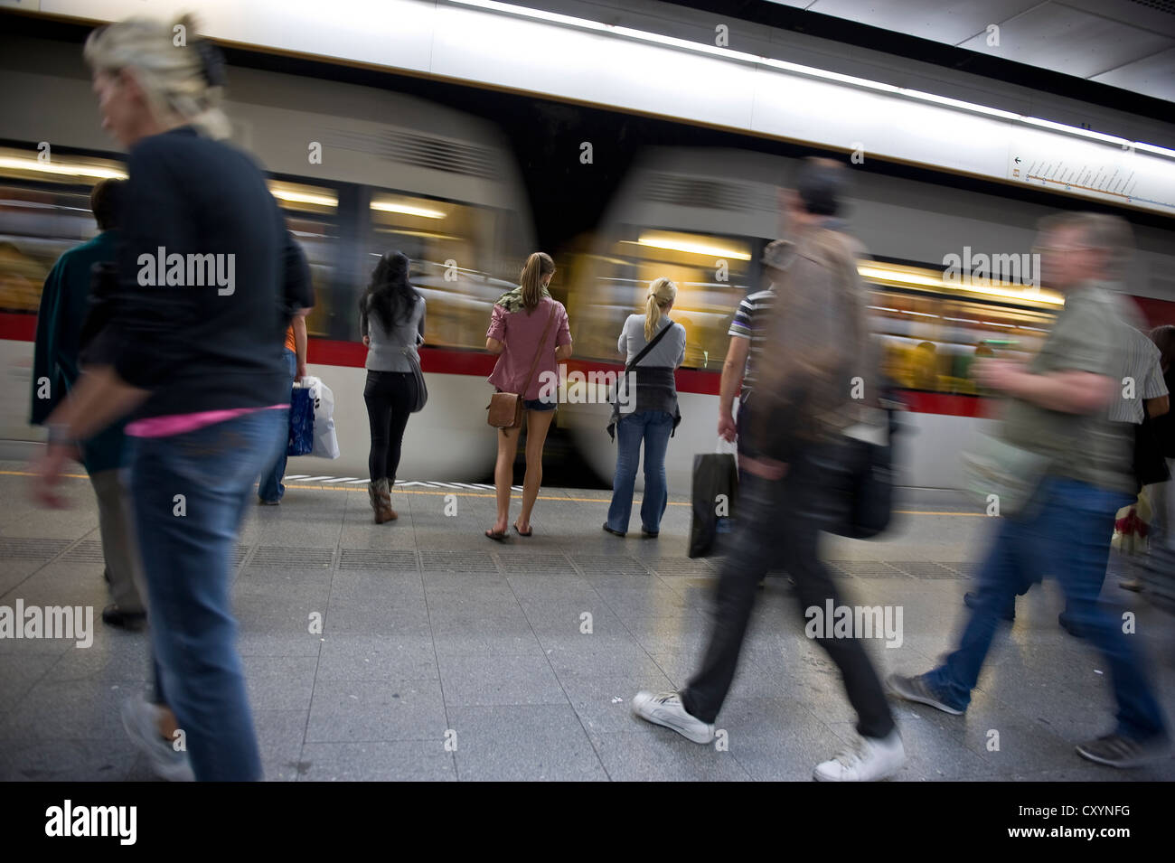 People waiting to get on an approaching underground train in Vienna, Austria Stock Photo