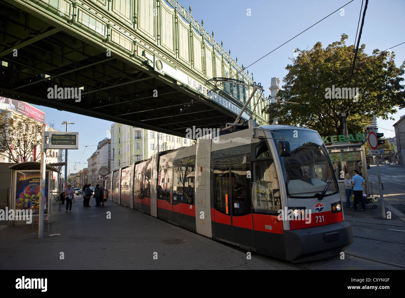 Electric Tram beneath a rail bridge at Wahringer Strasse, Vienna, Austria. Stock Photo