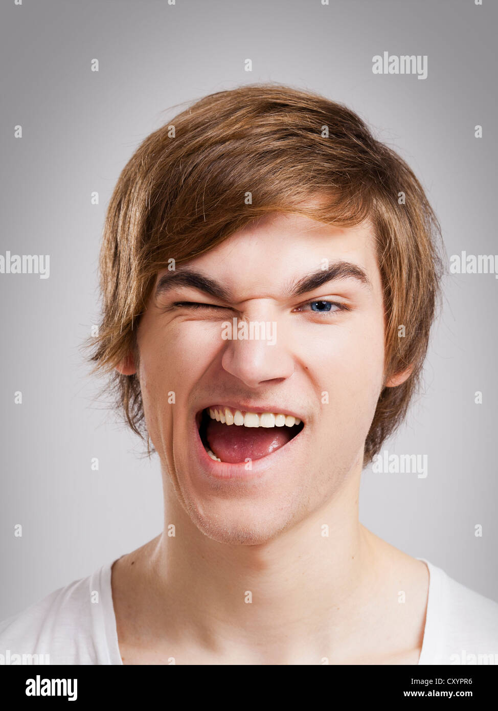 Portrait of a handsome young man, over a gray background Stock Photo ...