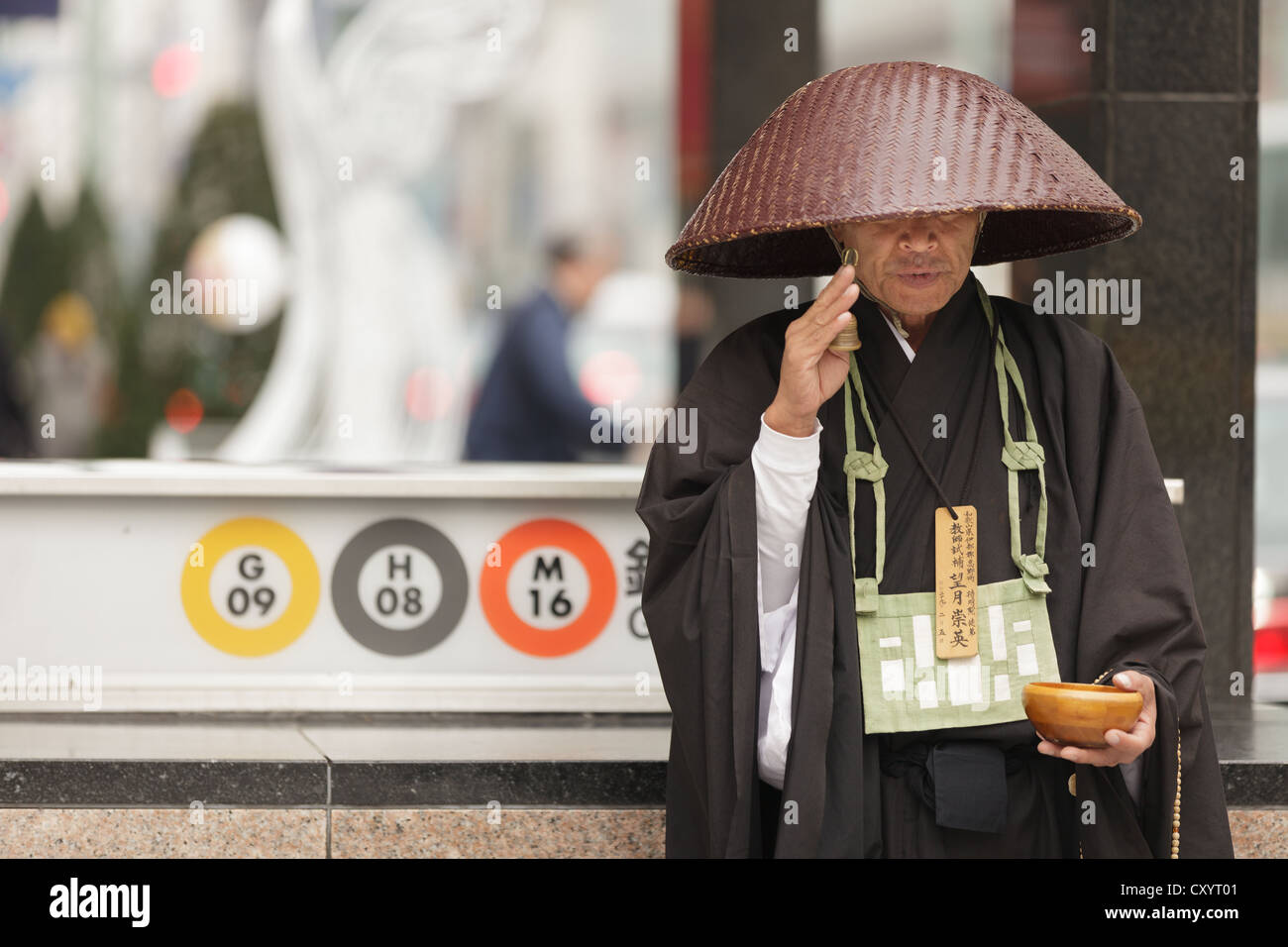 Buddhist sect member standing in Tokyo street, Japan Stock Photo Alamy