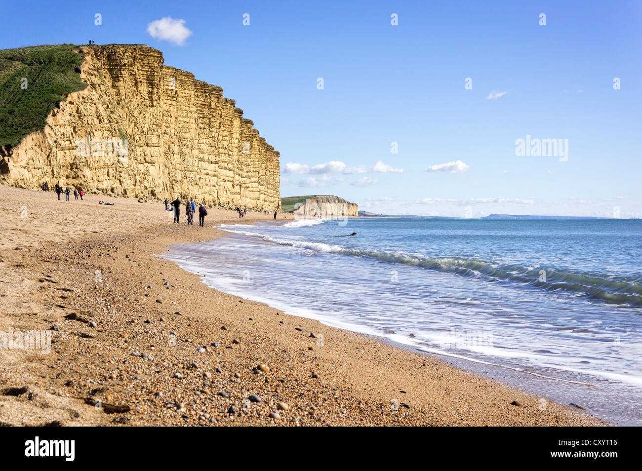 Beach at West Bay, Dorset, UK with Golden Cap cliff on the Jurassic Coast Stock Photo