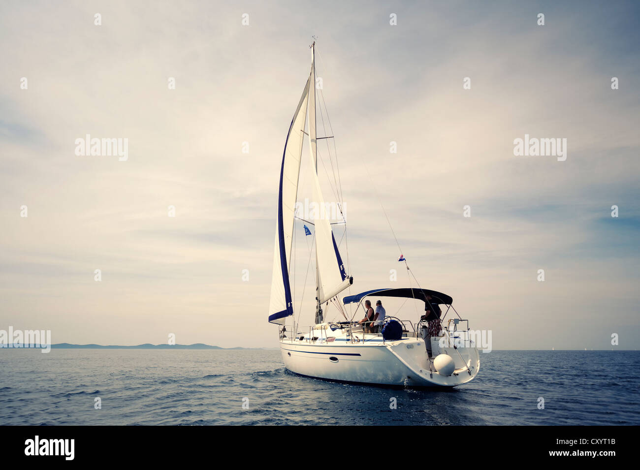 Rear view of a sailing yacht on the sea, no wind Stock Photo