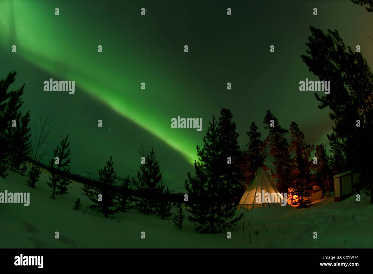 Illuminated, lit teepee, tipi, tepee, Northern polar lights, Aurora Borealis, green, near Whitehorse, Yukon Territory, Canada Stock Photo
