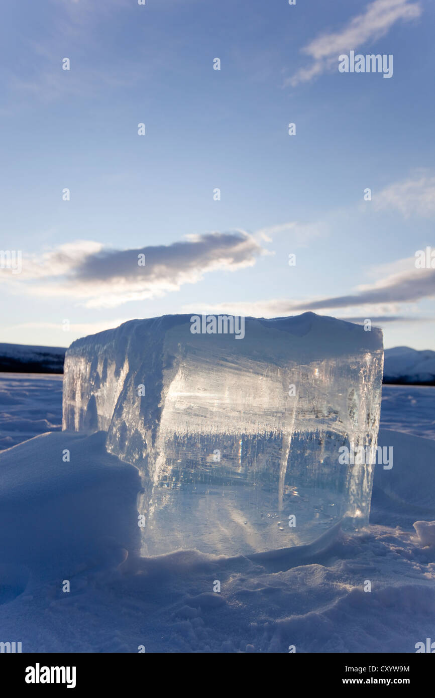 Clear ice cube on frozen Fish Lake, cut out with a chain saw, Yukon Territory, Canada Stock Photo
