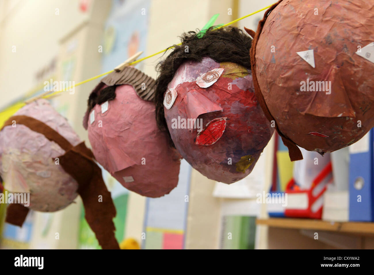 Papier Mache masks, made over balloons. Multi ethnic faces, London Primary School, UK Stock Photo