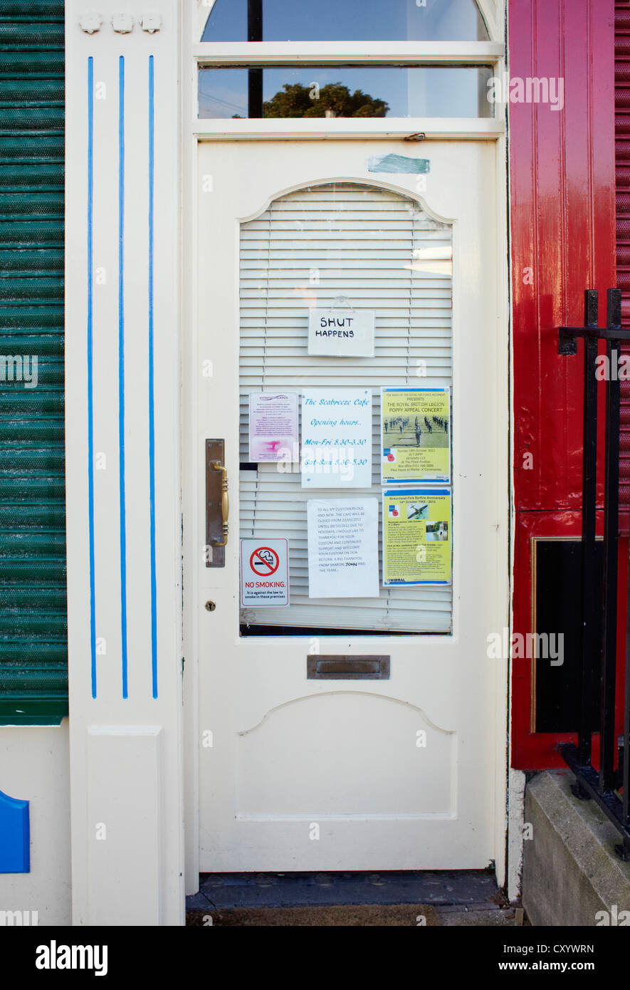 Door in cafe with sign saying 'shut happens' Stock Photo