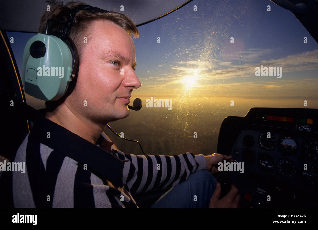 French pilot flying at dusk on a plane Robin DR400-120, France Stock Photo