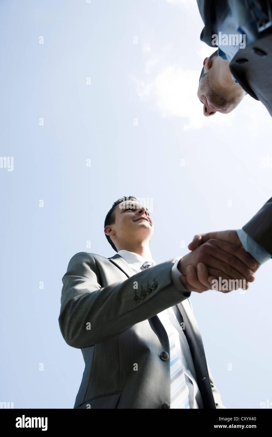 Two businessmen greeting each other with a handshake Stock Photo - Alamy